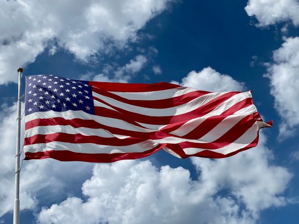 American flag waving against a blue sky